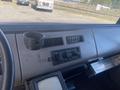 Interior dashboard of a 1997 Freightliner FL70 featuring controls for air conditioning and a cup holder