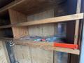 Inside a 2016 Continental cargo trailer with wooden shelves and some items including a plastic bottle and tools scattered across the surfaces