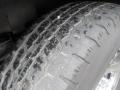Close-up of a tire from a 2011 Chevrolet Express showing tread pattern and surface details of the rubber