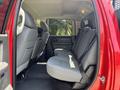 Interior view of a 2013 RAM 2500 showing the rear seating area with gray fabric seats and seatbelts