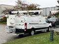 A 2019 Ford Transit work van with an elevated crane attachment on a raised platform at the rear