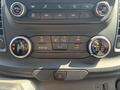 Control panel for a 2025 Ford Transit T-350 featuring air conditioning and climate control knobs with various buttons for ventilation settings