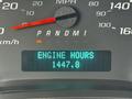 Dashboard of a 2013 Chevrolet Express showing the speedometer with a speed reading in miles per hour and a digital display indicating engine hours at 1447.8