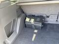 A black storage box is located in the cargo area of a 2015 Ford Escape