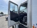 A 2018 Hino 338 truck with an open driver door revealing the interior featuring a steering wheel and dashboard
