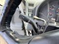 A close-up of the turn signal lever located on the steering column of a 2006 International 4300 truck