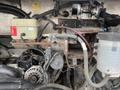 A 2012 Workhorse W62 engine compartment showing various components including hoses a coolant reservoir and a power steering fluid container