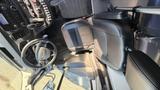 A 2021 Ford Transit interior showing the driver's seat steering wheel dashboard and gear shift