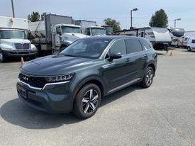 A 2022 Kia Sorento in a dark green color with a sleek design and alloy wheels parked on a lot
