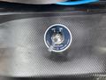 A circular battery switch labeled ON and OFF with a silver knob located on a textured black surface