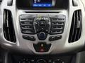 The interior dashboard controls of a 2017 Ford Transit Connect including audio and climate control buttons and a digital display