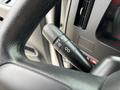 A close-up of a turn signal lever on a 2025 Peterbilt 536 showing control buttons for turn signals and windshield wipers