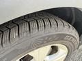 Close-up of a tire on a 2014 Ford Escape showcasing tread pattern and brand name General on the sidewall