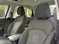 Interior view of a 2021 Kia Forte featuring two front seats with fabric upholstery and a central armrest