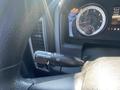 Close-up of the steering wheel and dashboard of a 2015 RAM 2500 featuring controls for wipers and other functions along with a speedometer and gear indicator