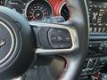 Close-up of a 2021 Jeep Wrangler steering wheel showing control buttons for cruise control and dashboard display features
