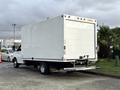 A white 2015 GMC Savana box truck with a smooth exterior and no visible markings parked at an angle with the rear doors facing outward