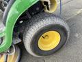 Close-up of a tire from a 2021 John Deere L Series S featuring a textured surface and bright yellow hub