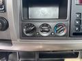 Control panel of a 2020 Peterbilt 330 featuring knobs for airflow and temperature settings as well as a gear shifter displayed in a compact layout