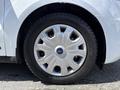 Close-up of a silver wheel rim with a Ford logo on a tire from a 2021 Ford Transit Connect