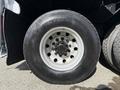 Close-up of a wheel from a 2008 Kenworth T370 showcasing the black tire with brand markings and multiple lug nuts visible on the wheel rim