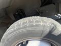 Close-up of a worn tire on a 2009 Workhorse W62 showing visible tread patterns and dirt accumulation on the rubber surface