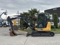 A 2017 John Deere 50G excavator with a dark green track and yellow body, featuring a front digging arm and bucket attached