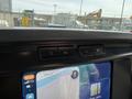 Interior dashboard of a 2021 Ford F-150 featuring control buttons and a touchscreen display showing navigation and connectivity options