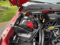 Engine compartment of a 2013 Ford F-550 showing the battery and various engine components