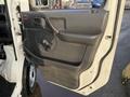 The interior door panel of a 2008 Suzuki Carry featuring a door handle a manual window crank and textured material