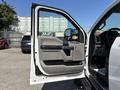 The image shows the open driver's side door of a 2017 Ford F-550 with a gray interior and control panel visible inside