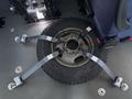 A 2020 Chevrolet Express with a tire secured to the floor using four gray straps attached to metal anchors