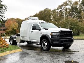 A white 2024 RAM 5500 truck with an extended cab and a custom cargo box on the back