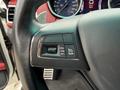 Close-up of the steering wheel controls of a 2016 Maserati Ghibli featuring buttons for cruise control settings