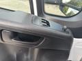 Close-up of the door control panel in a 2023 RAM Promaster 3500 featuring window controls and a knob for adjusting mirrors