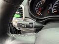 A close-up view of the control stalk for the windshield wipers in a 2019 Jeep Grand Cherokee featuring various settings for both front and rear wipers