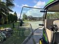 A 2021 John Deere 1575 lawn mower with a partially open door showcasing its interior controls and seating
