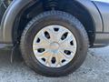 Close-up of a 2017 Ford Transit-350 wheel featuring a silver alloy rim and a thick tire with a tread pattern designed for durability