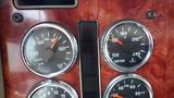 Dashboard gauges of a 2003 International 5600i truck displaying pressure temperature and fluid levels