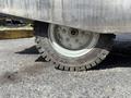 A close-up of a tire from a 2023 Bitimec SC415 showing tread patterns and metallic components