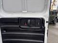 Interior door handle of a 2022 GMC Savana with a smooth black panel and lock button visible