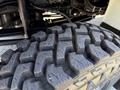 Close-up of a rugged tire tread from a 2009 International 3000 CE showing deep grooves designed for traction and durability