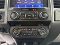 Interior dashboard of a 2020 Ford F-550 featuring audio controls climate controls and infotainment system display