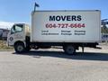A white 2014 Hino 195 moving truck with black text advertising moving services and a phone number displayed on the side