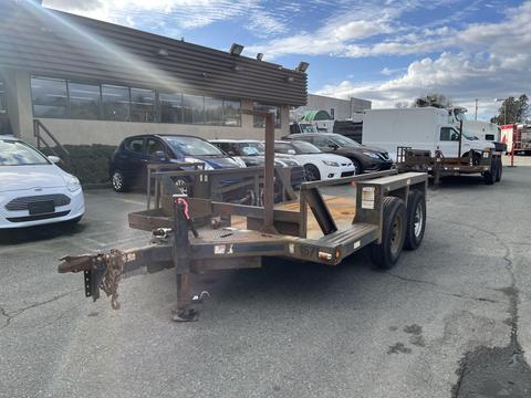 A 2013 JLG Industries Flat Deck Trailer with two axles and a metal frame designed for transporting equipment or heavy loads