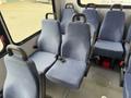 Interior seating of a 2017 Chevrolet Express with multiple blue fabric seats arranged in a row featuring seat belts