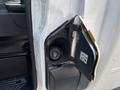 A close-up of the fuel door of a 2018 Ford Transit-350 showing the cap and surrounding area with a label inside