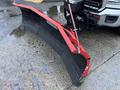 A red snow plow attached to the front of a 2017 GMC Sierra 3500HD truck