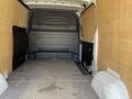 Interior of a 2022 Mercedes-Benz Sprinter van showing a spacious cargo area with wood paneling and grey flooring