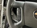 Close-up of the steering wheel of a 2020 Chevrolet Express showing control buttons for settings and cruise control
